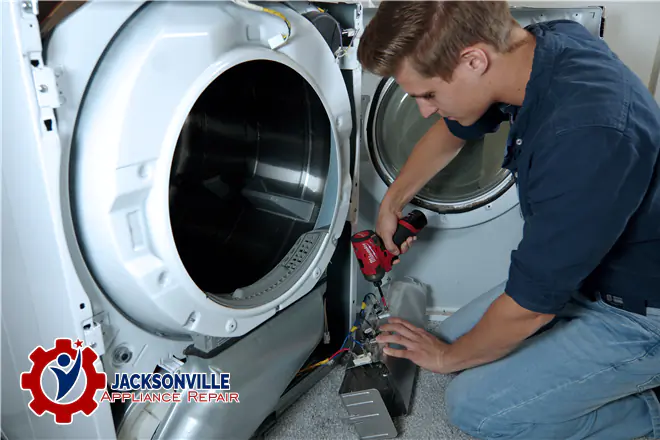 The technician is repairing the dryer