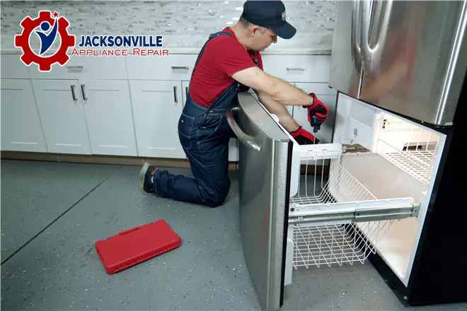 The technician is repairing the freezer