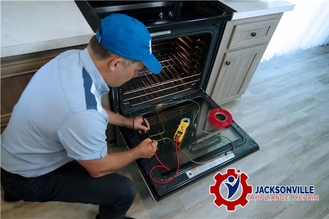 The technician is repairing the oven