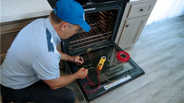 The technician is repairing the oven